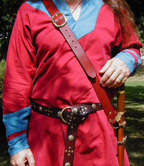 Our Versatile Baldric in Chestnut Leather shown from the front with sword hanging vertically.