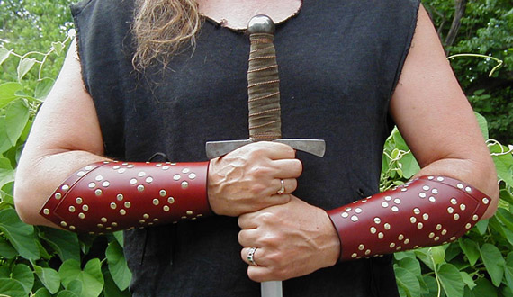 Warlord Studded Bracers shown in chestnut leather with brass studs.