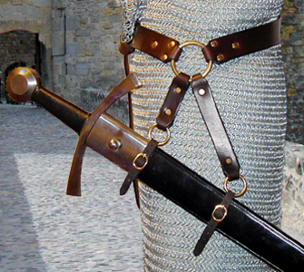 Our Sword Belt of the Circle is based on an example in a late Medieval painting. Shown side view in dark brown leather with brass hardware.