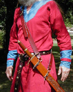 Our Versatile Baldric in Chestnut Leather shown from the side with sword hanging at an angle.