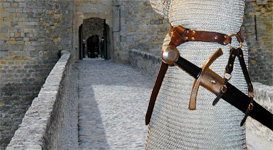 Our Sword Belt of the Circle is based on an example in a late Medieval painting. Shown side view in dark brown leather with brass hardware.