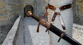 Our Sword Belt of the Circle is based on an example in a late Medieval painting. Shown side view in dark brown leather with brass hardware.